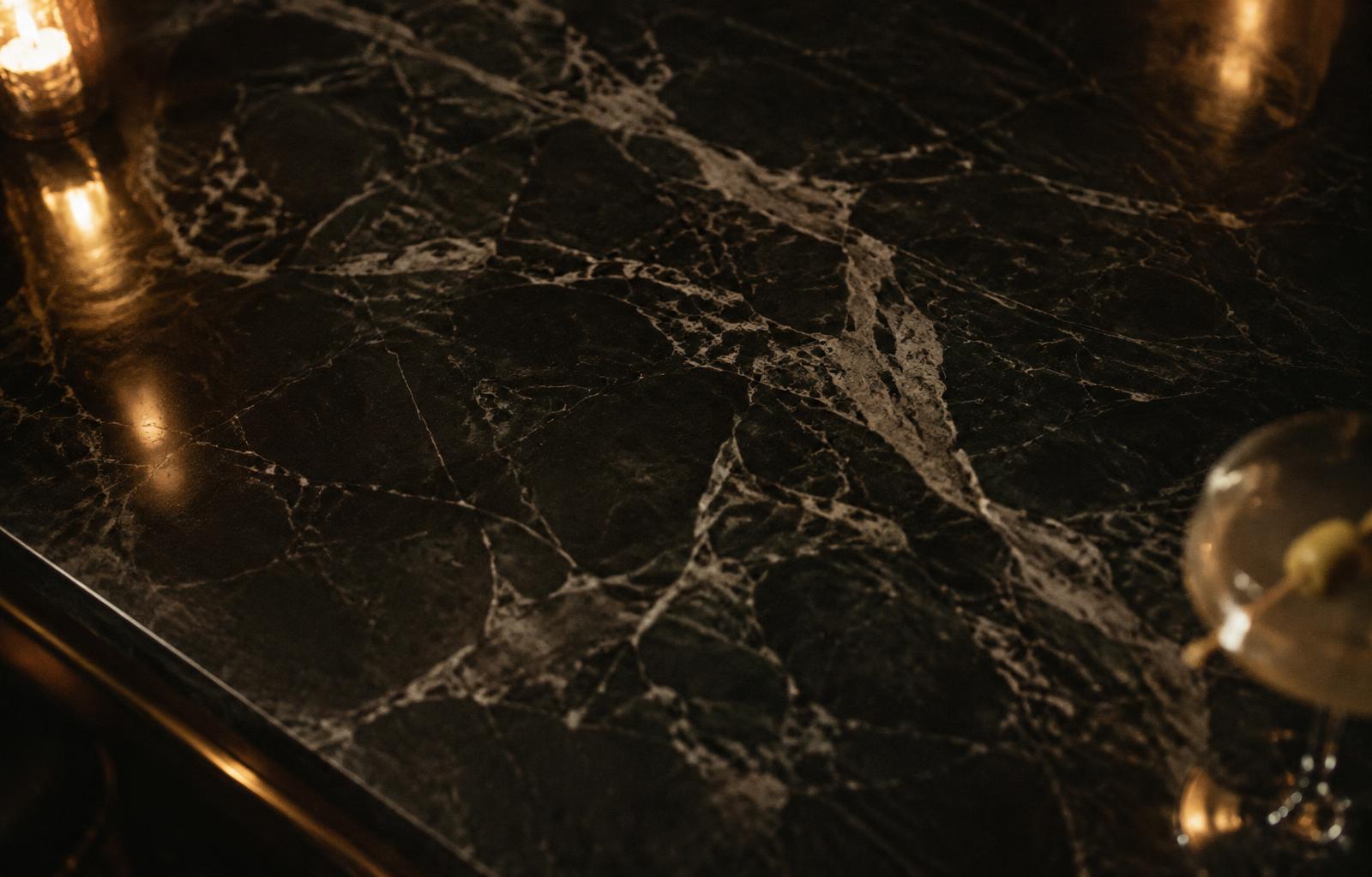 Dark marble bar top in low light